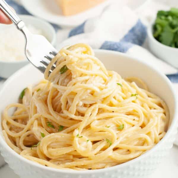 Bowl of spaghetti alfredo with a fork.