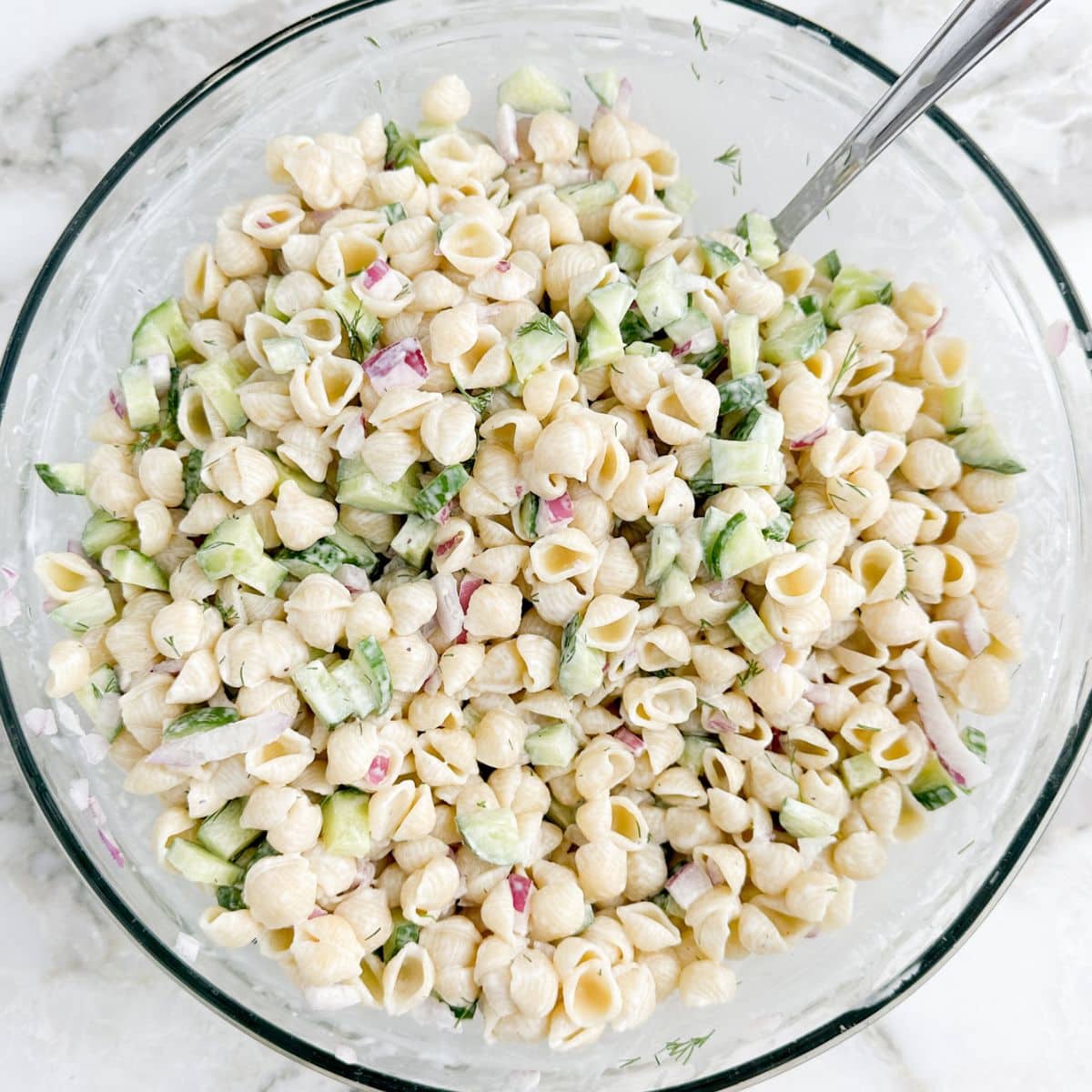 Bowl of cucumber pasta salad.