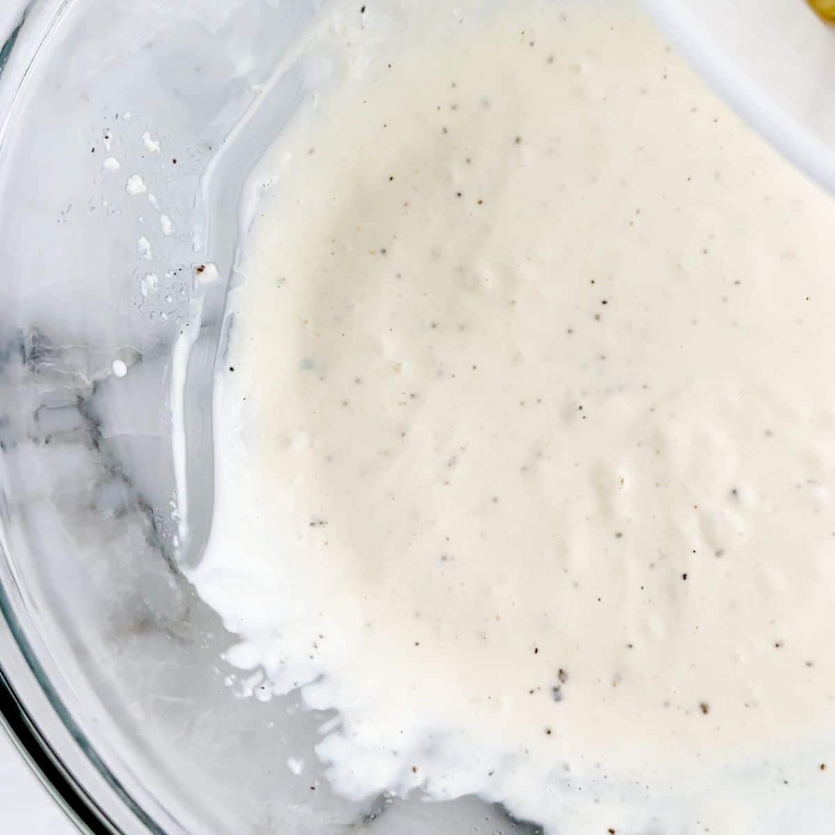 Bowl of creamy pasta salad dressing.