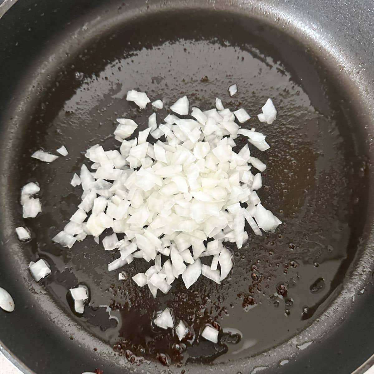 Skillet with diced onion.