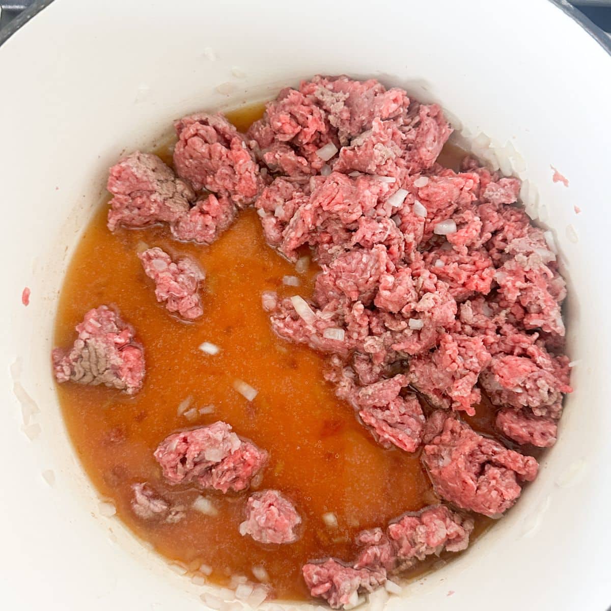 Pot with ground beef and beef broth.