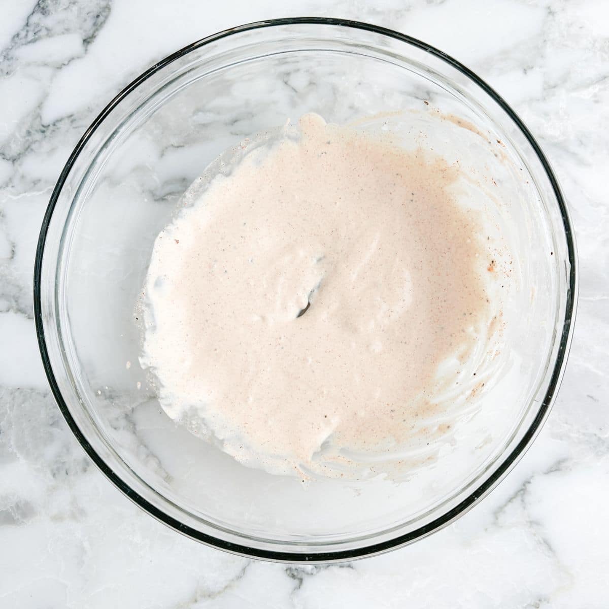 Bowl of mayonnaise chicken marinade.