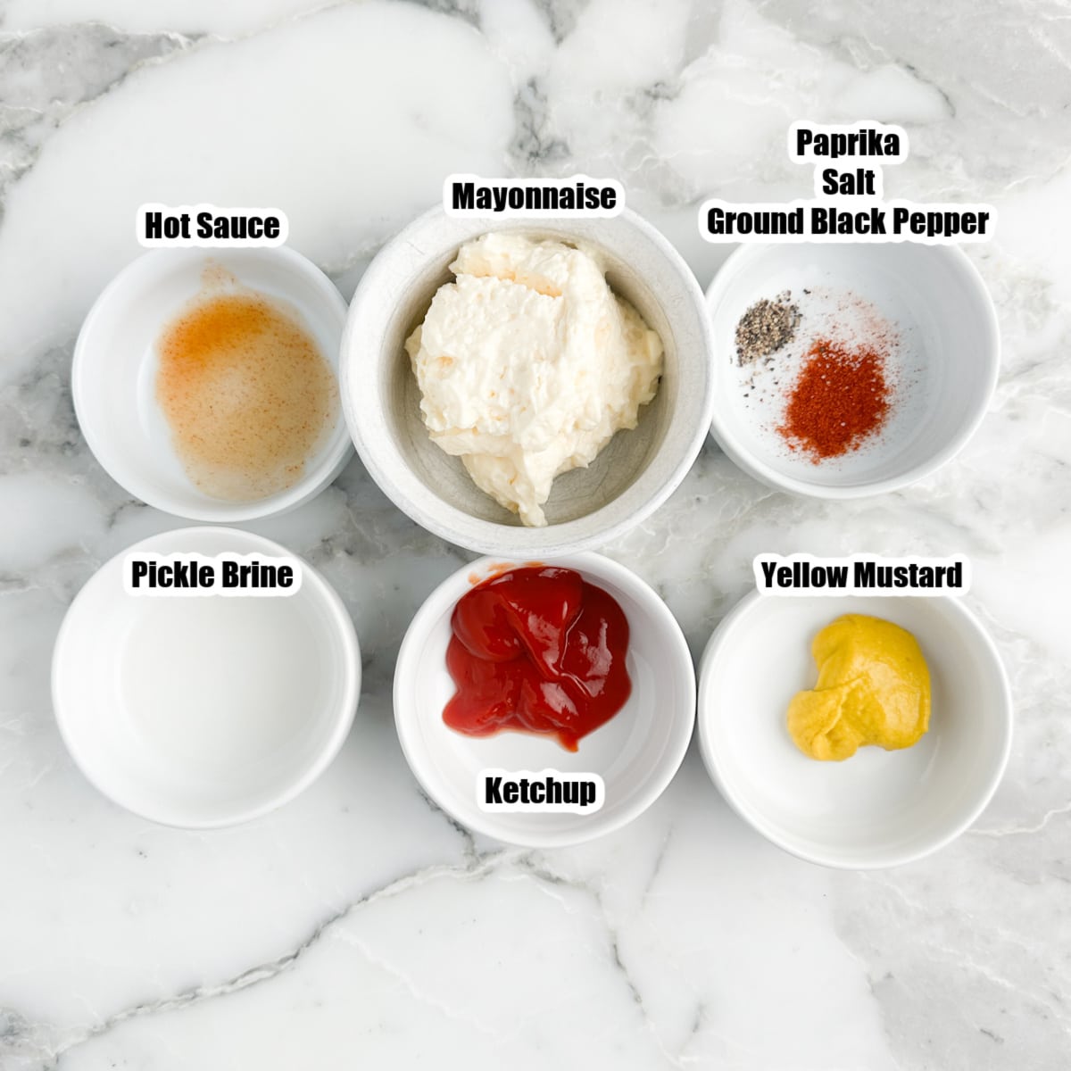 Bowls of ketchup, mustard, mayonnaise, seasonings, hot sauce, and pickle juice.