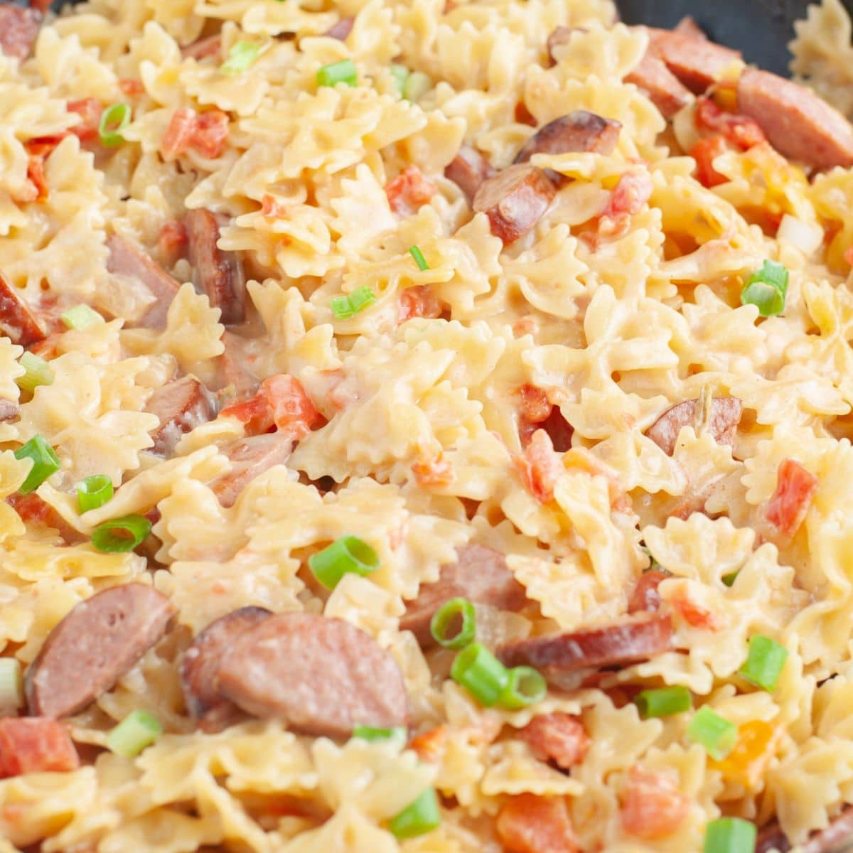 Sausage and pasta in a skillet.