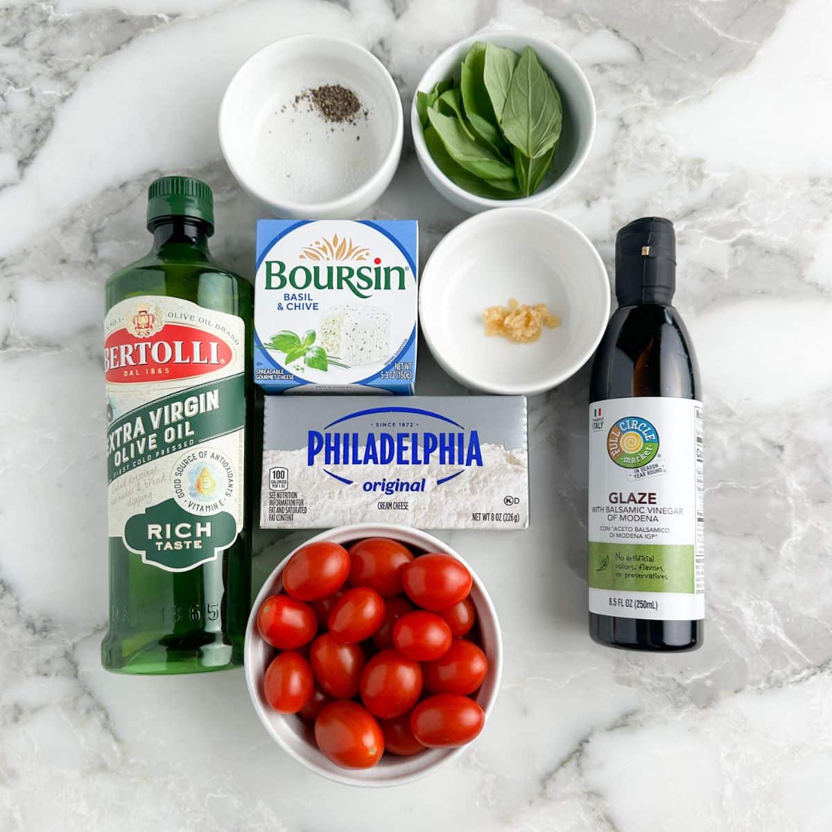 Extra virgin olive oil, balsamic glaze, tomatoes, cream cheese, Boursin cheese, and basil leaves.