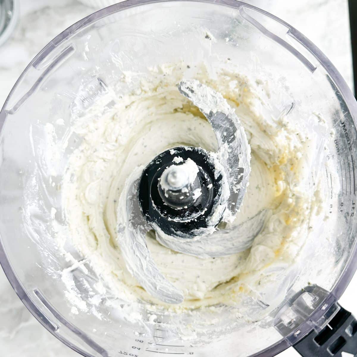 Food processor with creamed cream cheese.