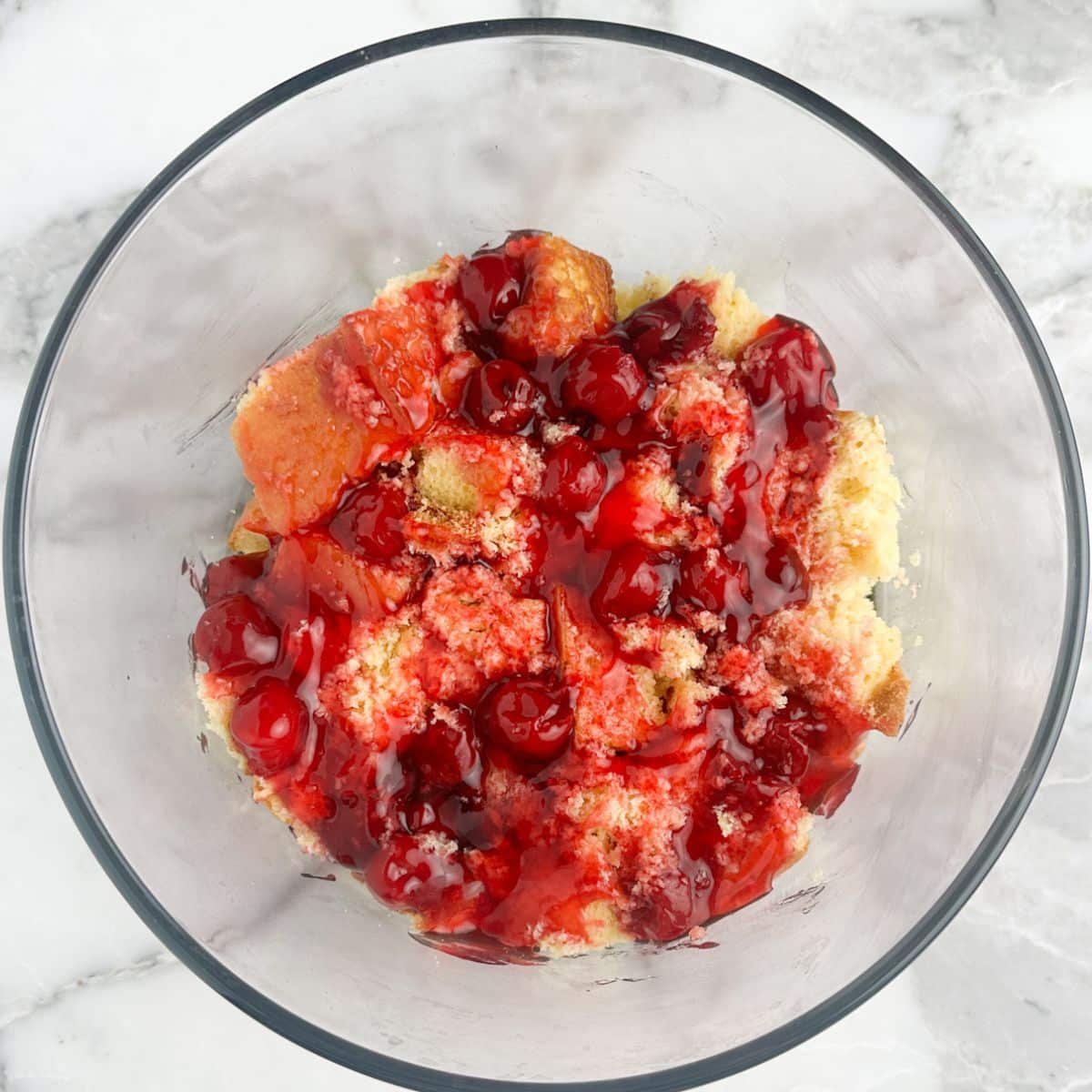 Bowl with cake and cherry pie filling.