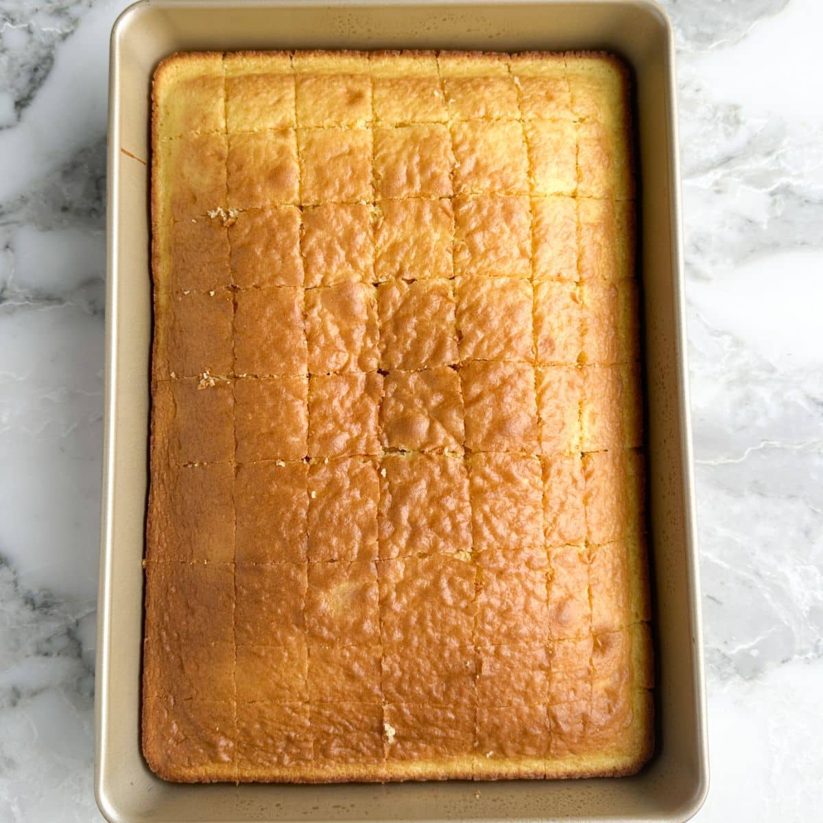 9 x 13 baking pan with a baked, yellow cake.