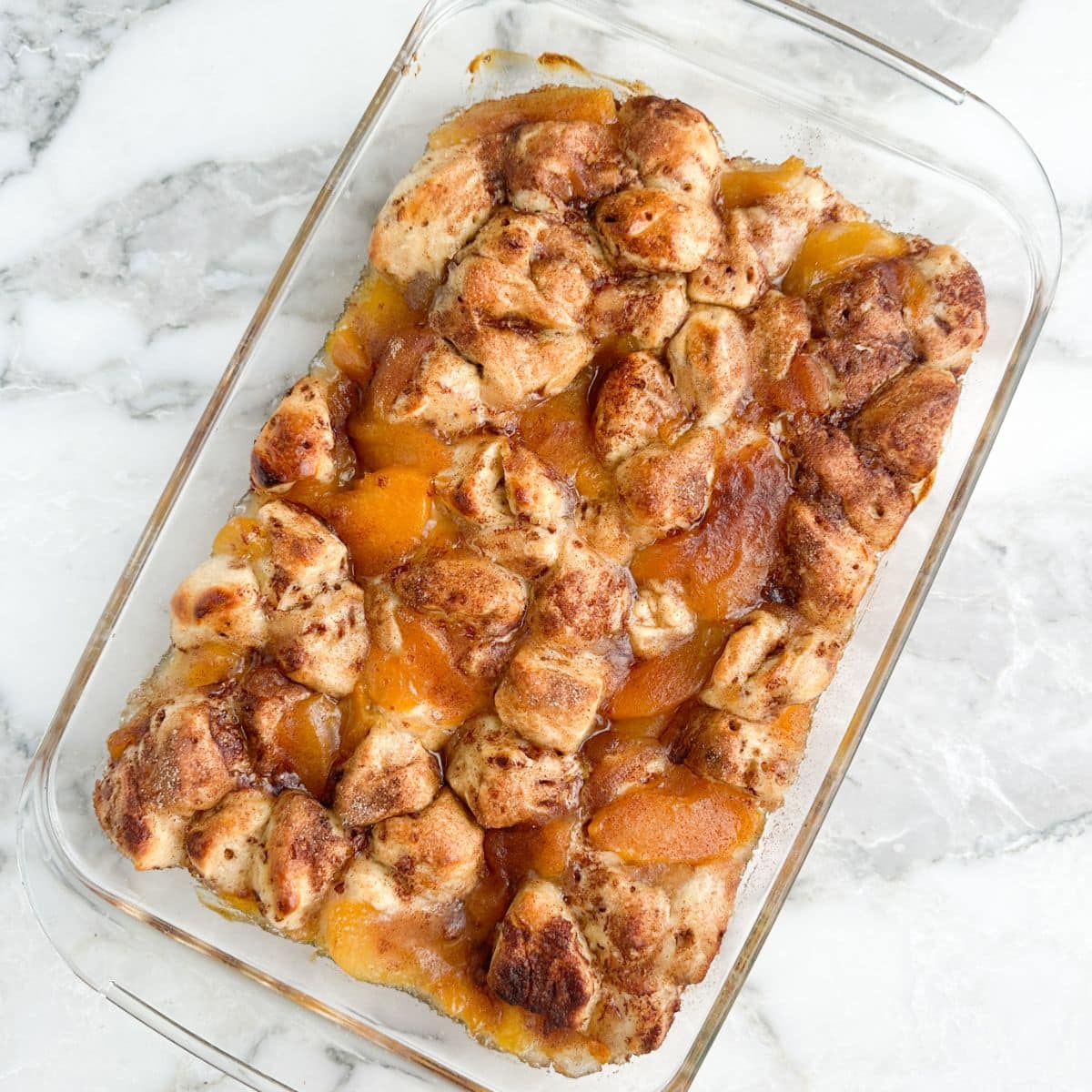 Baked cinnamon roll peach cobbler.