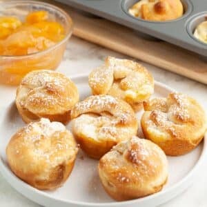Plate of mini crescent peach cheesecakes.