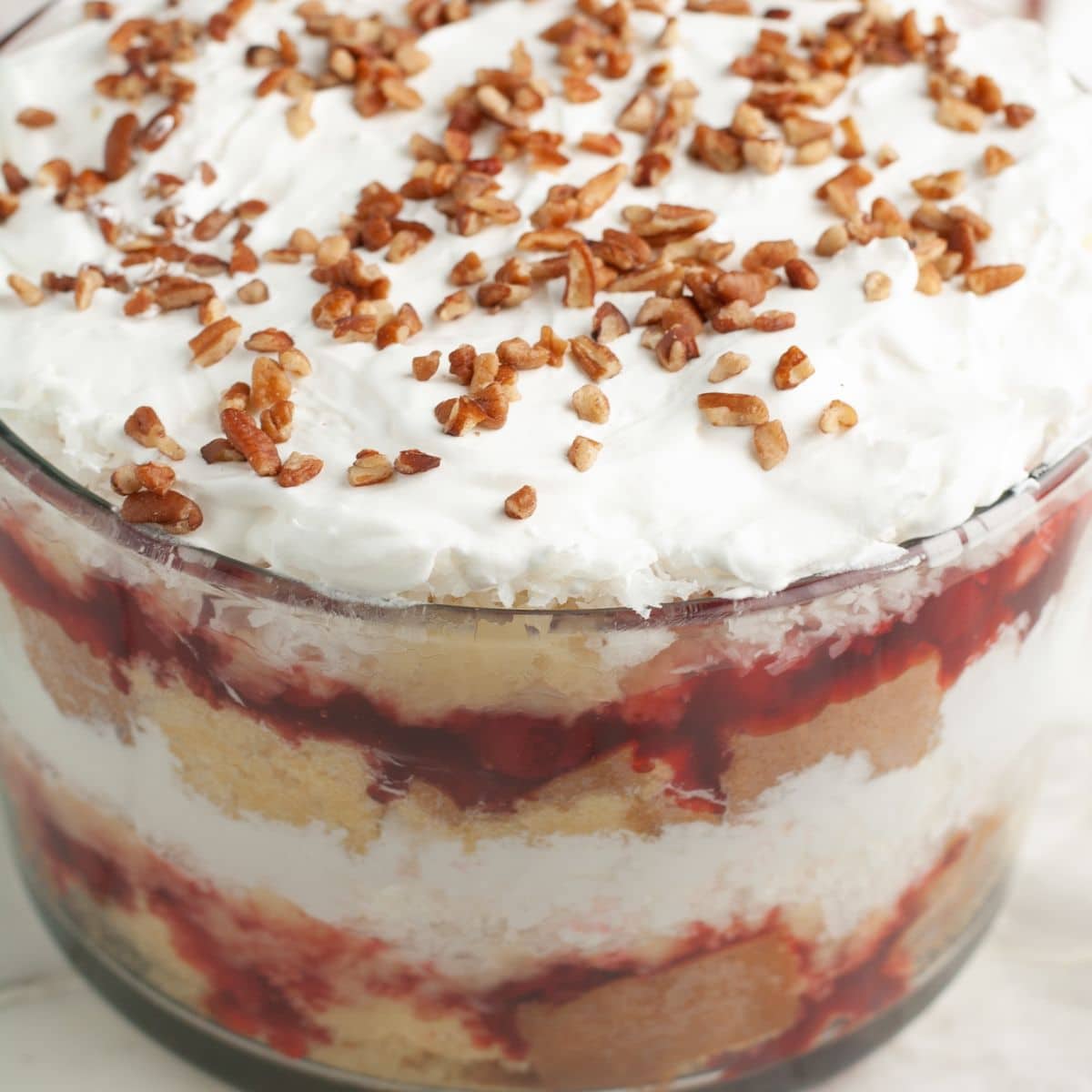 Punch bowl cake in a clear bowl.