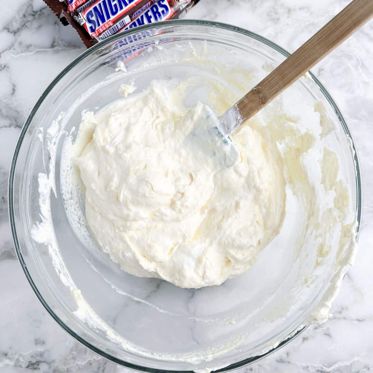 Bowl of creamy pudding with a spatula.
