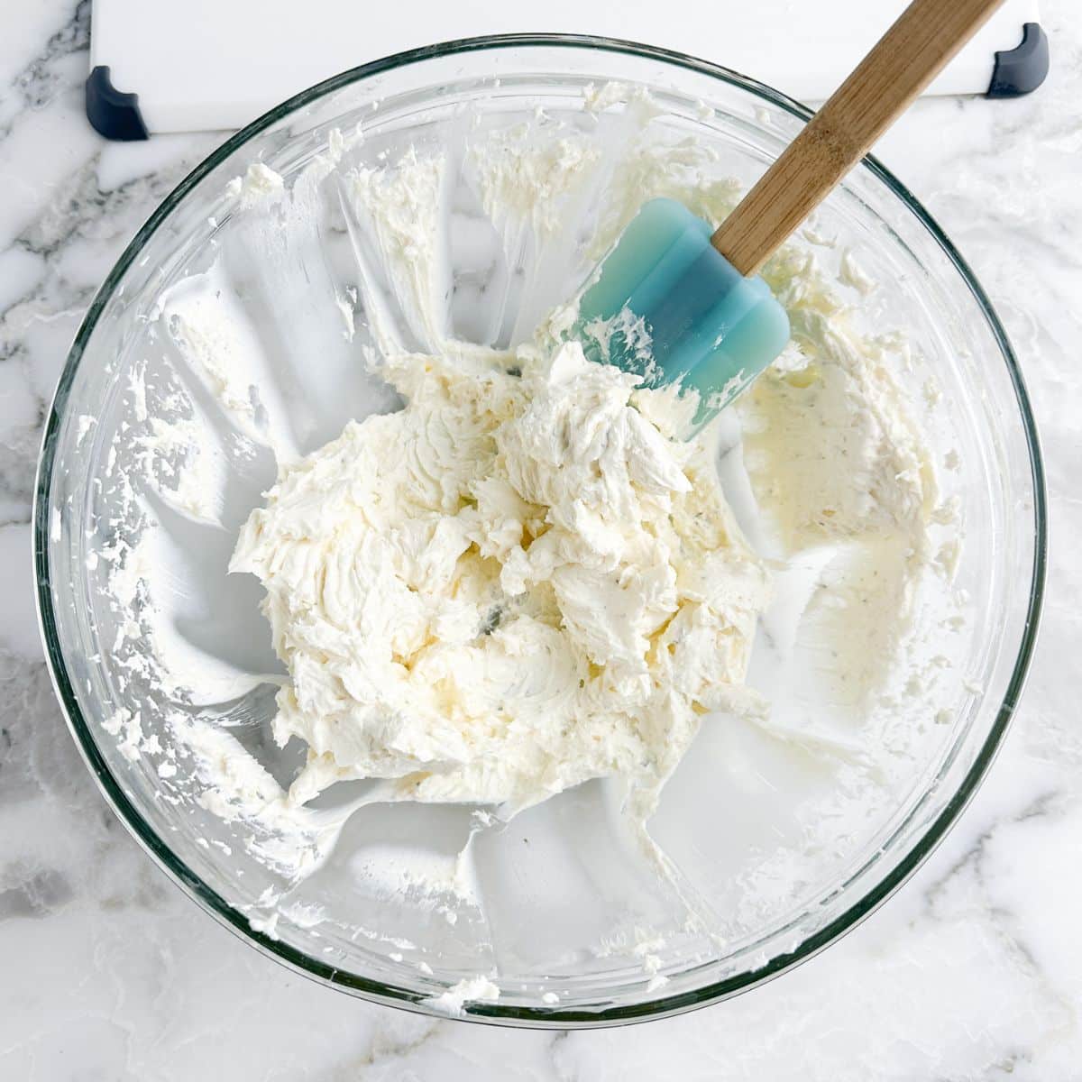 Bowl with creamed cream cheese and a spatula.