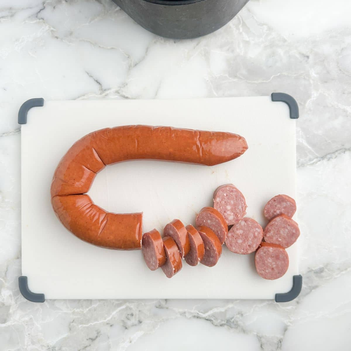 Cutting board with sliced kielbasa. 
