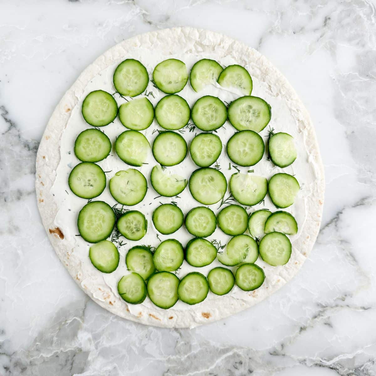 Tortilla with cream cheese and sliced cucumbers. 