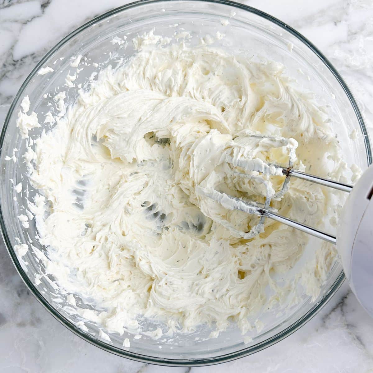Bowl of beaten cream cheese.