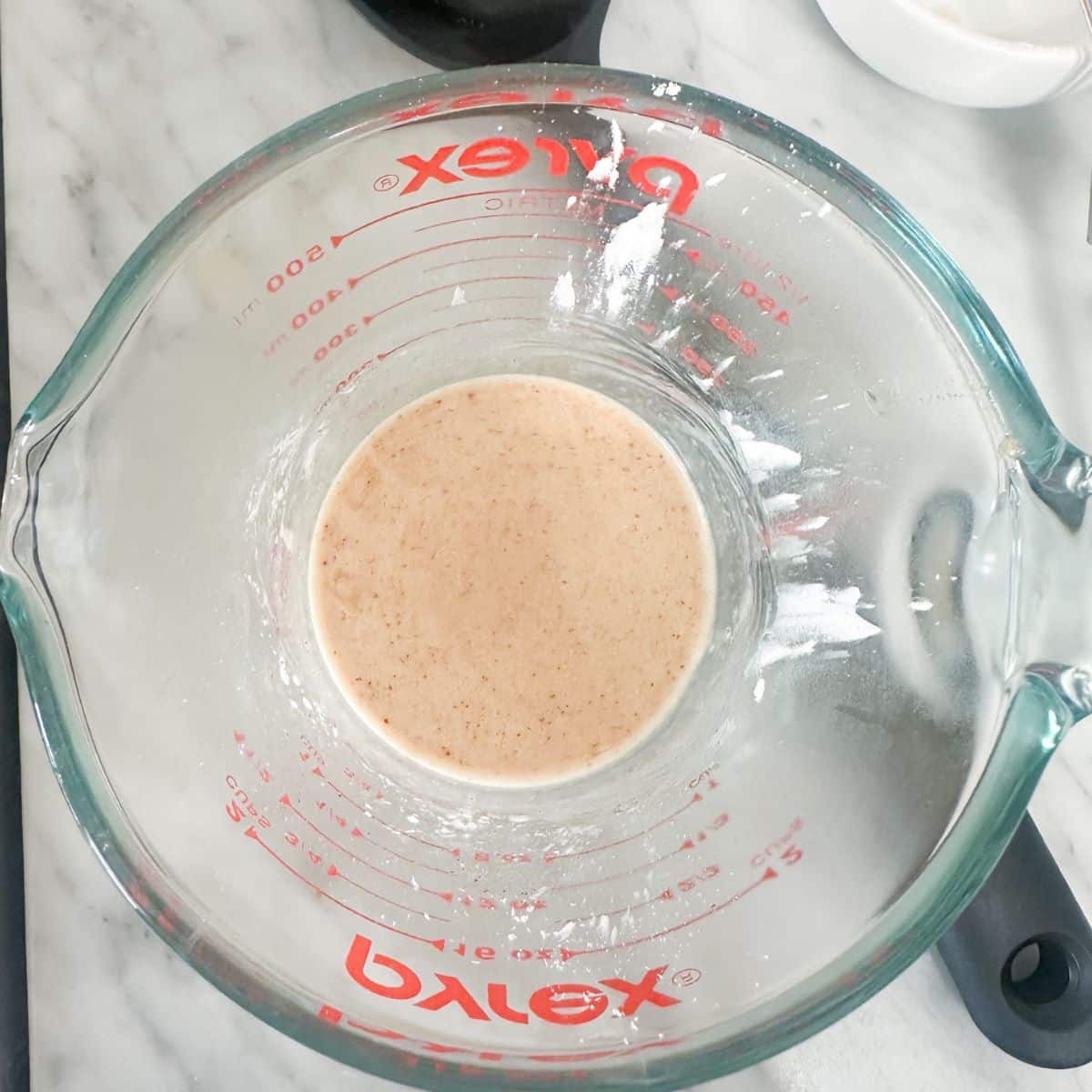 Measuring cup with cornstarch slurry. 