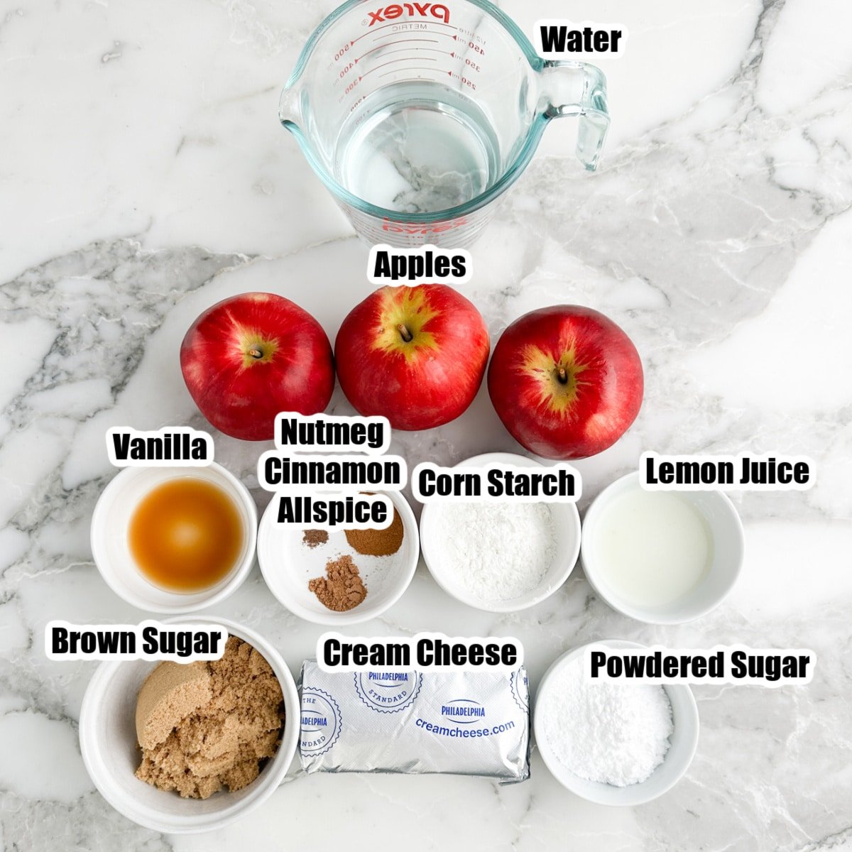 Water, apples, bowls of brown sugar, spices, corn starch, lemon juice, vanilla, sugar, and cream cheese.