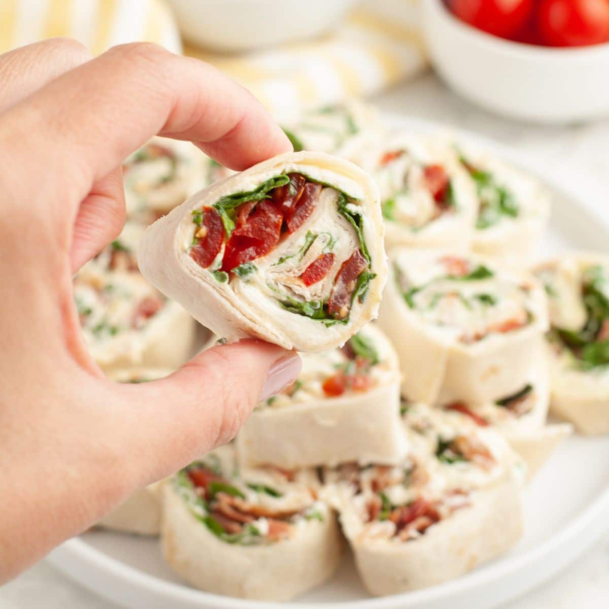 Hand holding a BLT pinwheel.