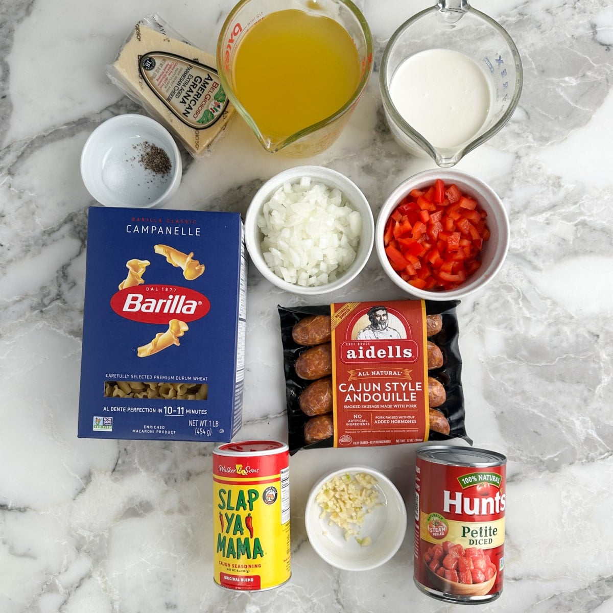 Box of pasta, andouille sausage, broth, milk, canned tomatoes, and seasonings.