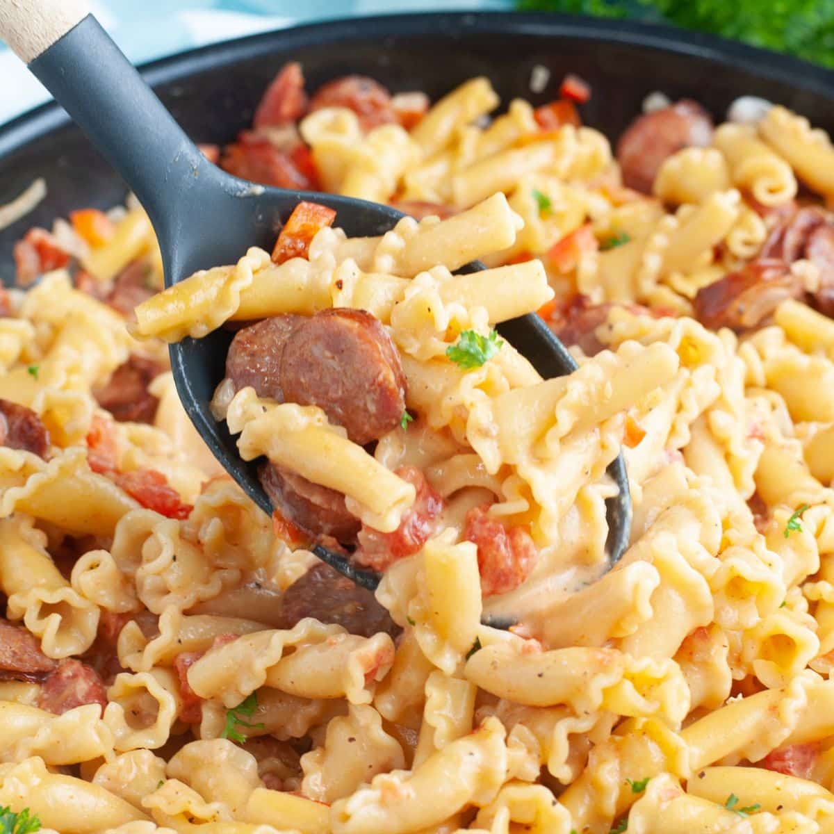 Spoon with cajun sausage pasta. 