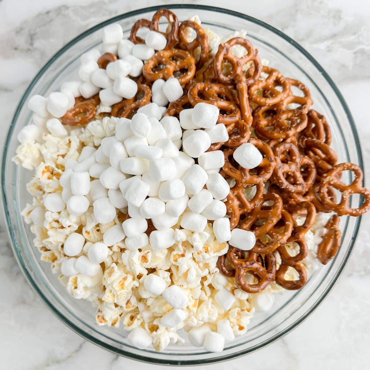 Bowl of popcorn, marshmallows, and pretzels.