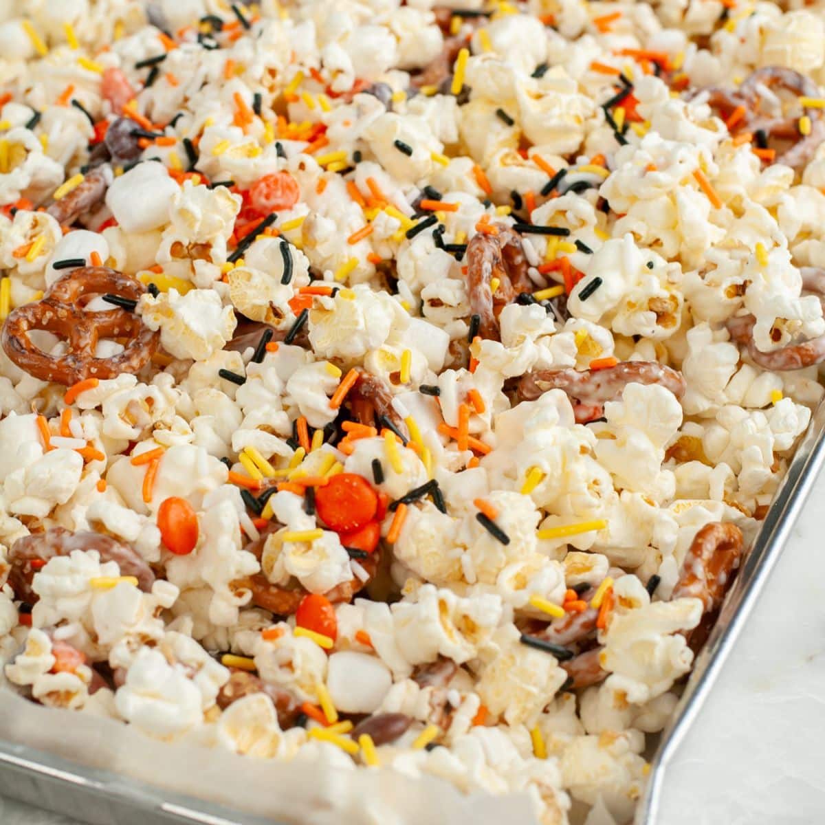 Pan with popcorn snack mix.