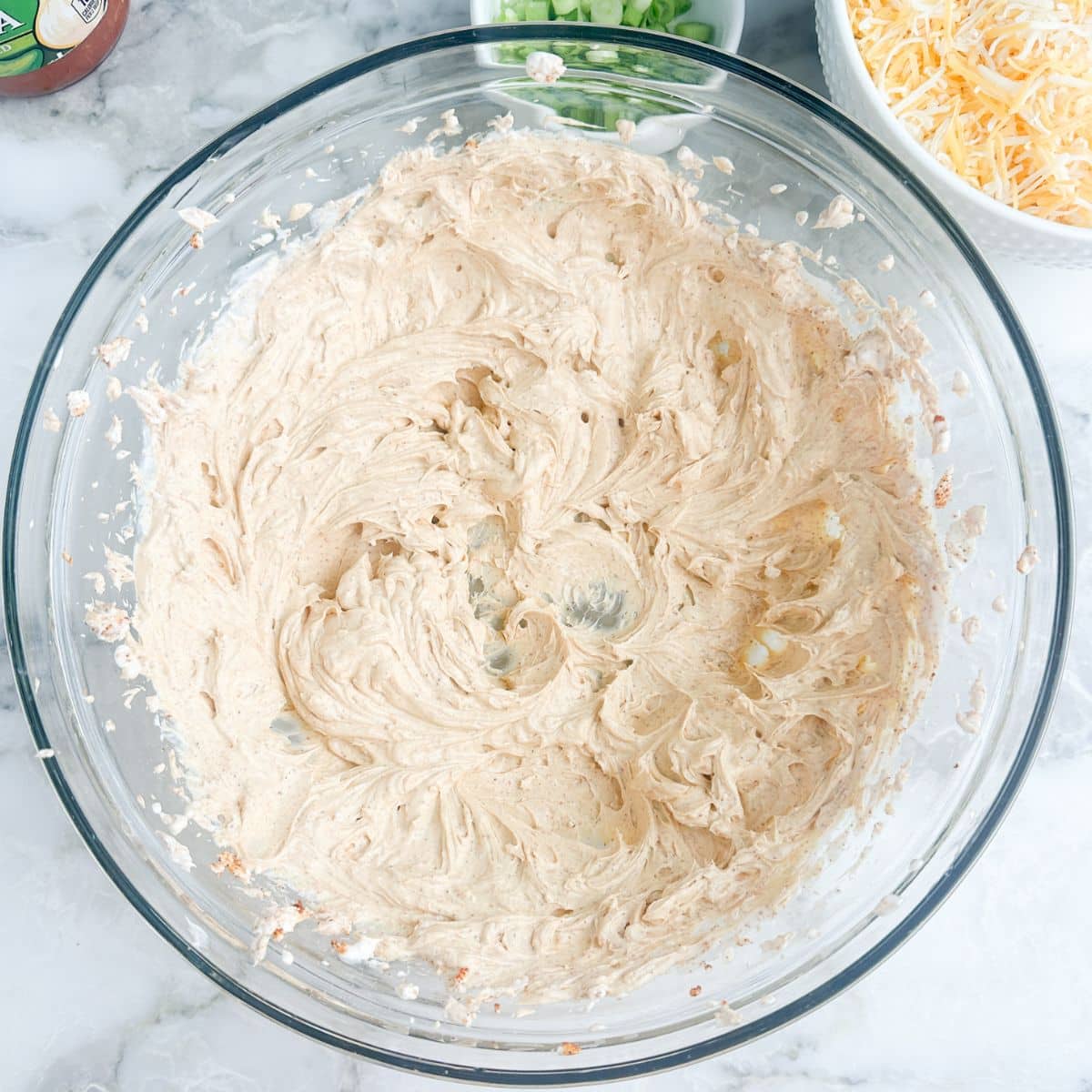 Bowl of creamed cream cheese with taco seasoning.