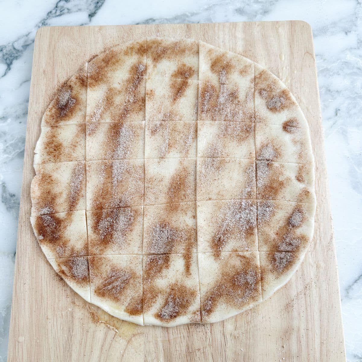 Pie crust with cinnamon and sugar cut into squares.