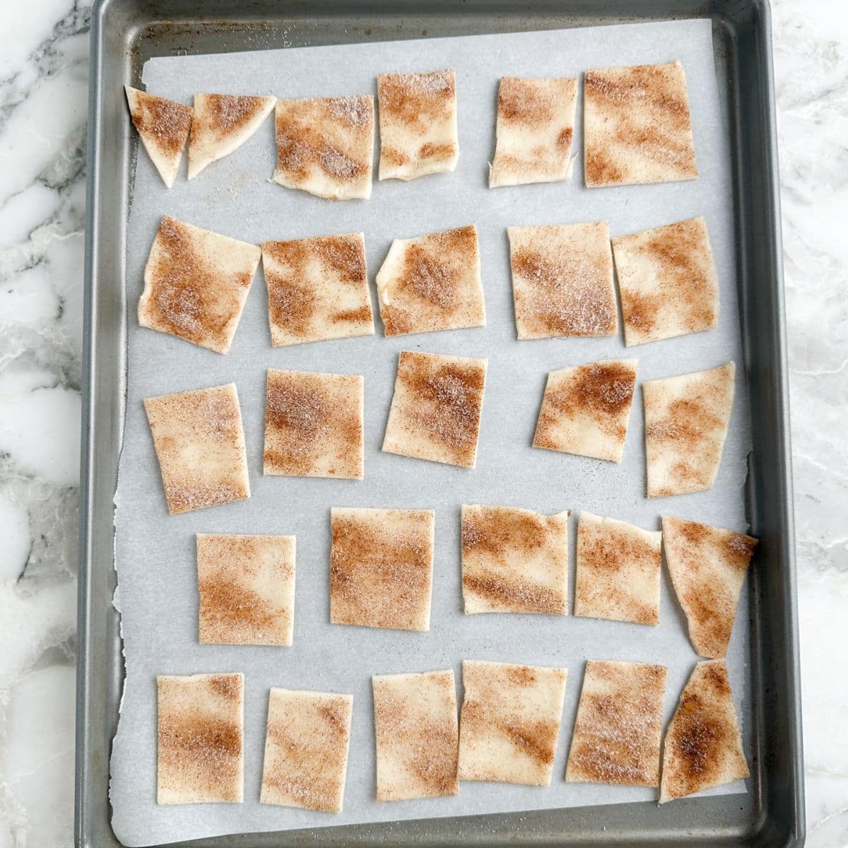 Sheet pan with uncooked pie crust chips.
