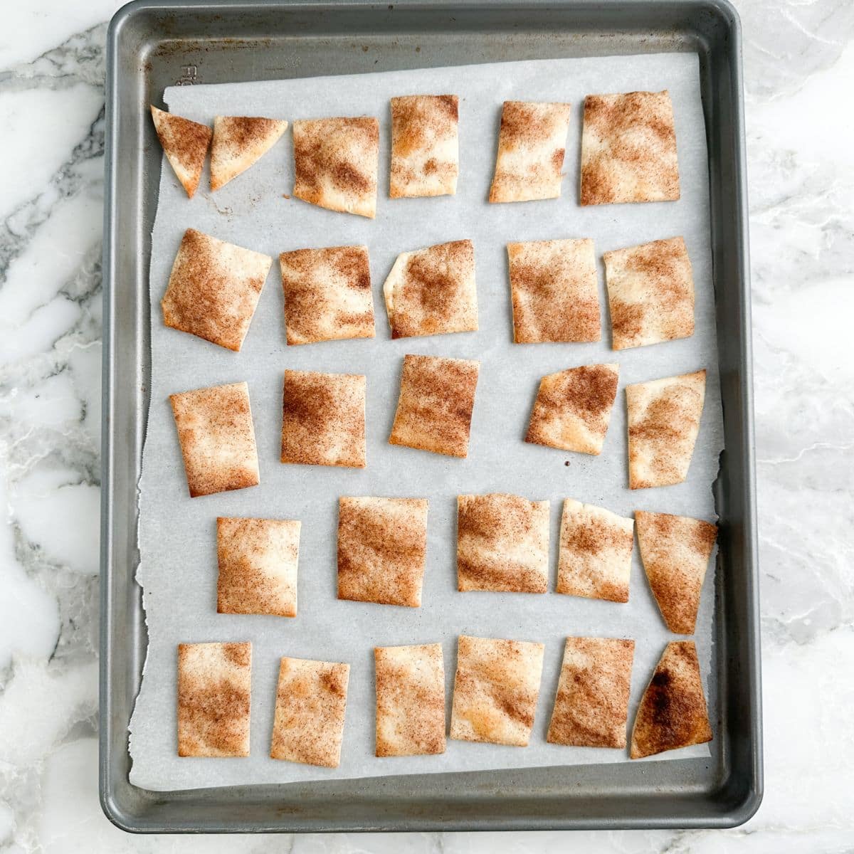 Baked pie crust chips on a sheet pan.