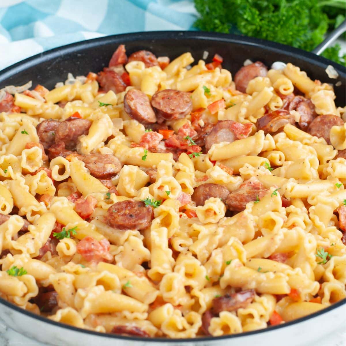 Skillet with cajun sausage pasta.