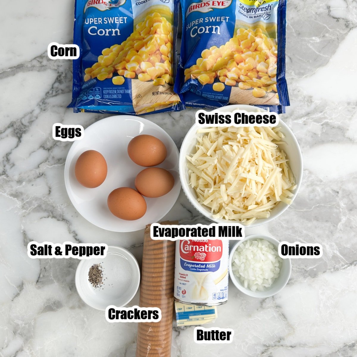 Bags of corn, eggs, shredded Swiss cheese, crackers, evaporated mik, onions, and butter. 