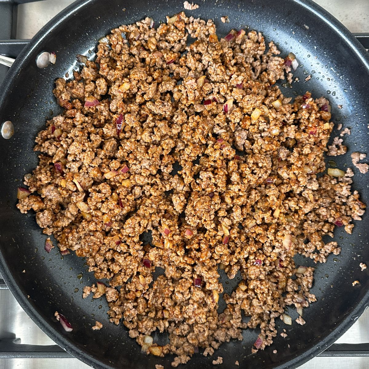 Skillet with cooked ground beef. 