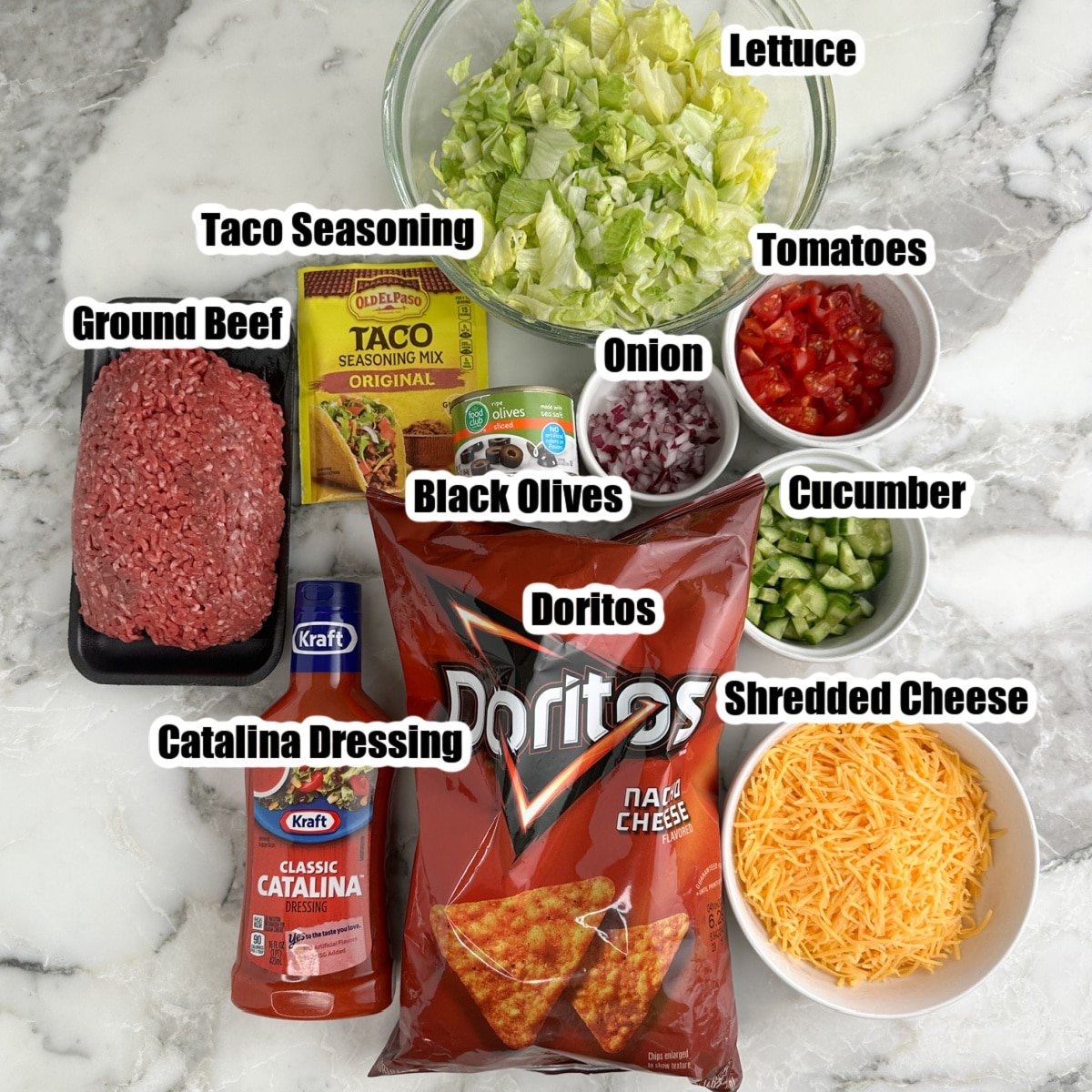 Ground beef, lettuce, cheese, Doritos, Catalina dressing, taco seasoning, diced tomatoes. 
