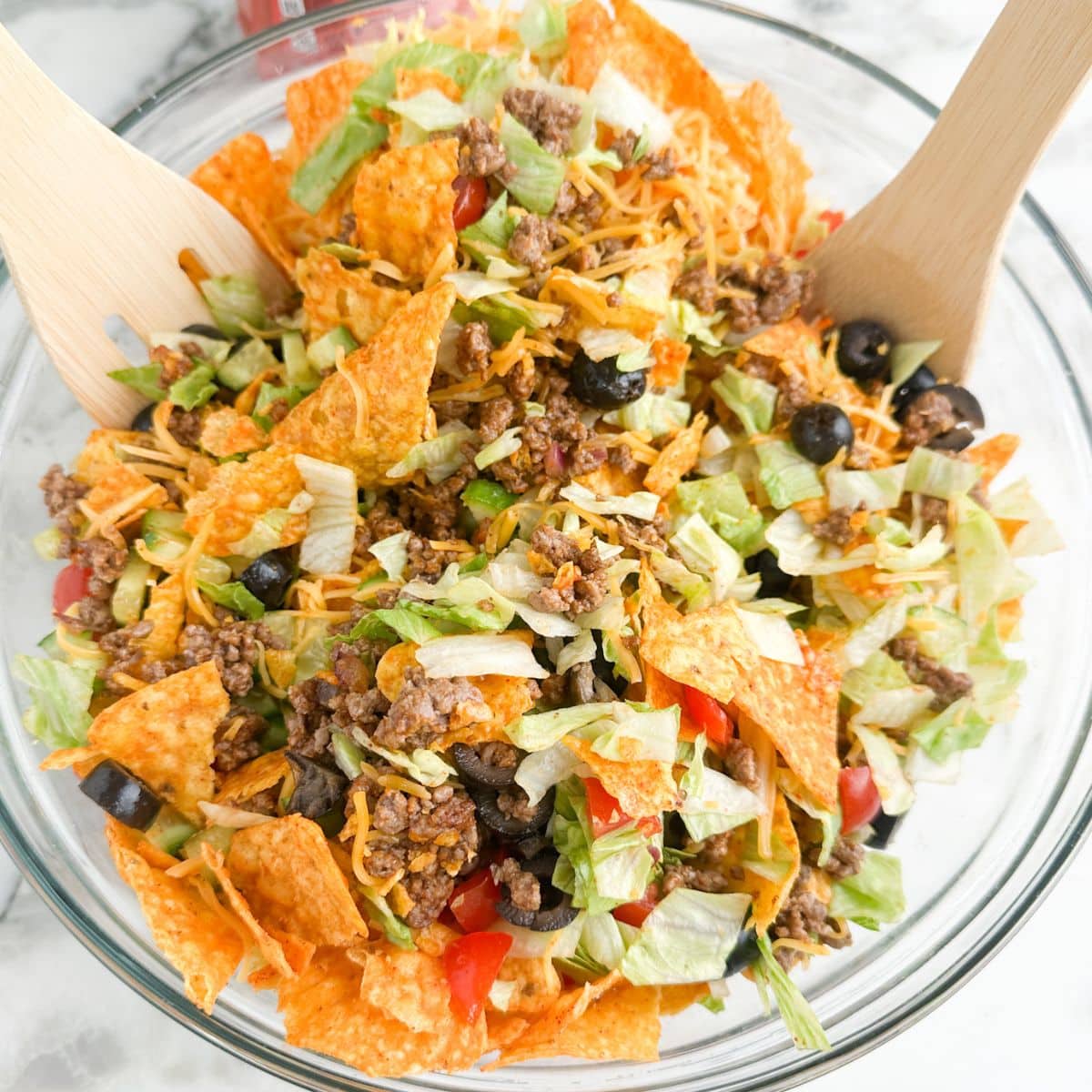 Bowl of Dorito taco salad with spoons. 