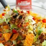 Spoon with taco salad.