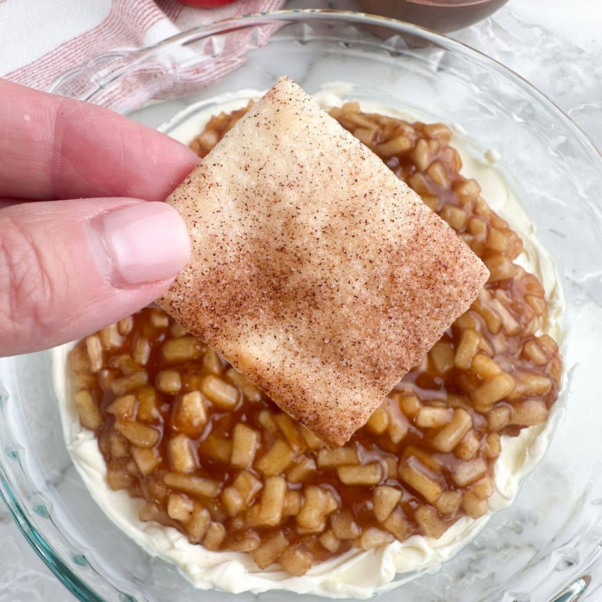 hand holding pie crust chips.
