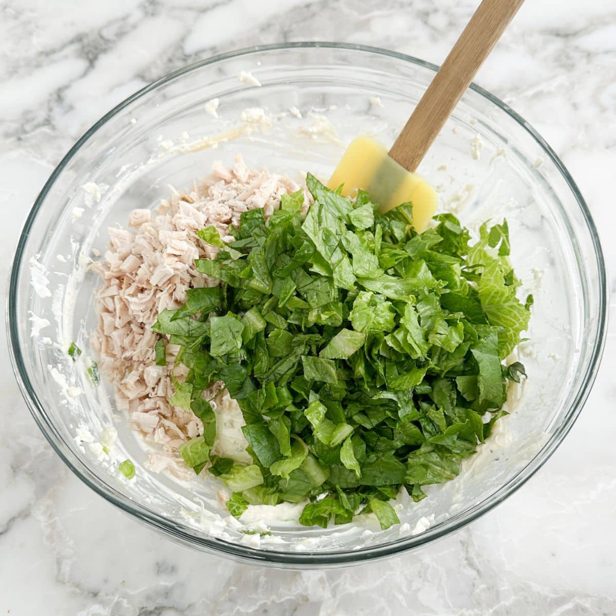 Bowl or shredded chicken, chopped lettuce, and cream cheese mixture.