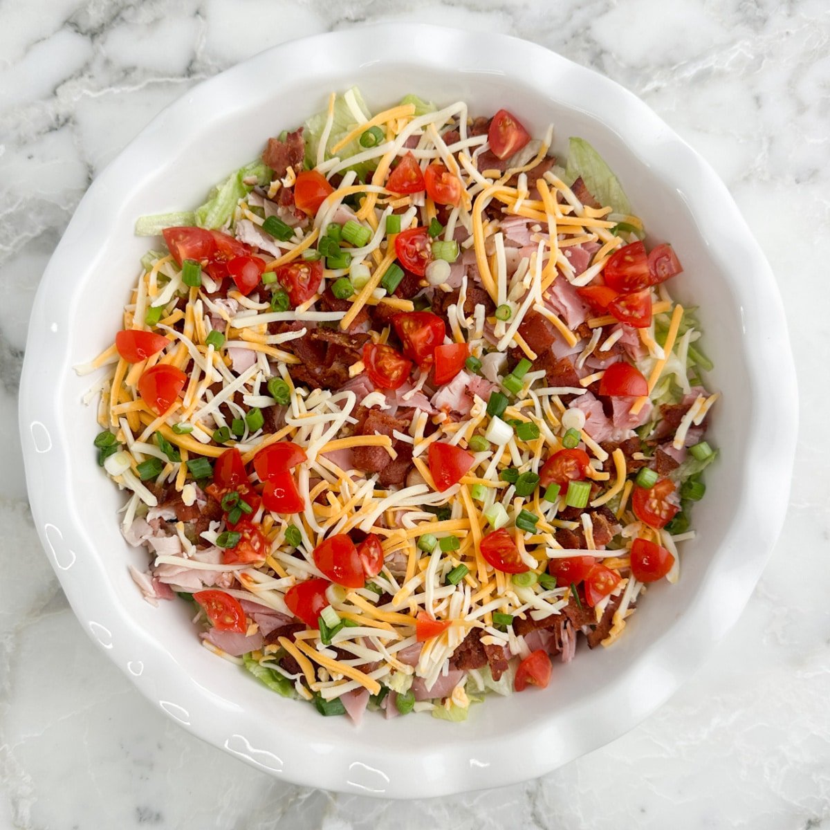 Club sandwich dip in a serving dish.