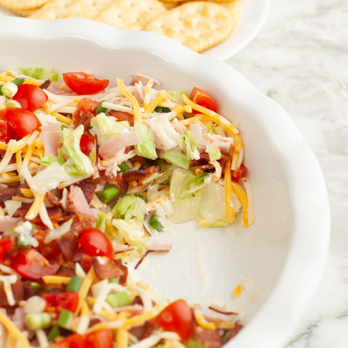 Baking dish with club sandwich dip.