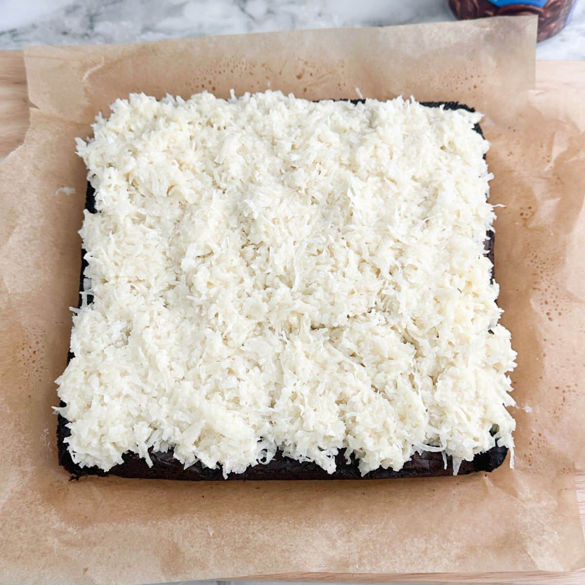 Brownies topped with shredded coconut mixture.