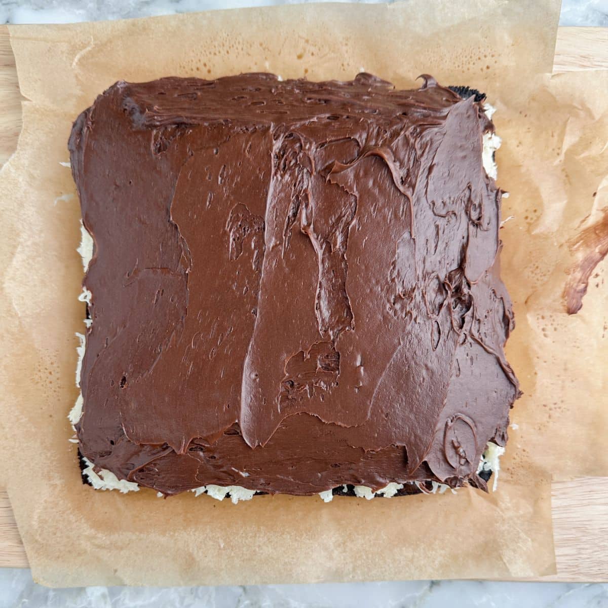 Brownies topped with coconut and chocolate frosting. 