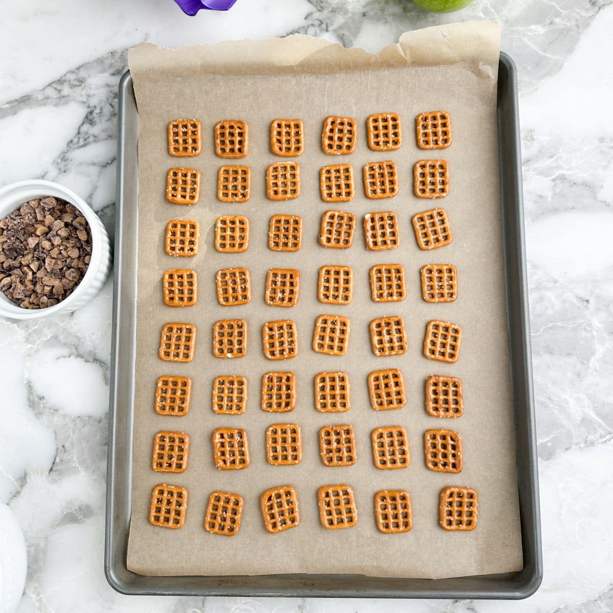 Baking pan with square pretzels.