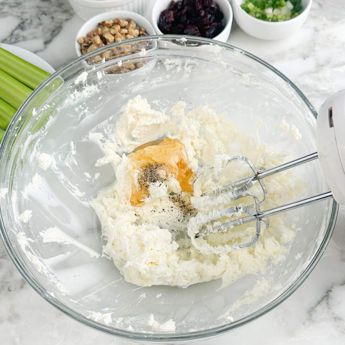 Bowl of whipped cream cheese with honey and seasonings.