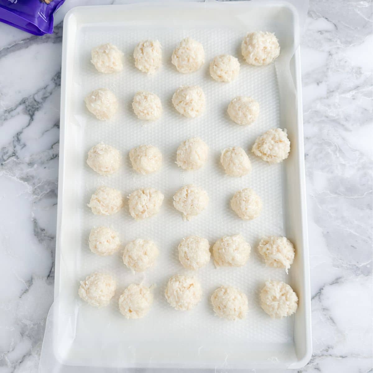 Baking pan with coconut balls.