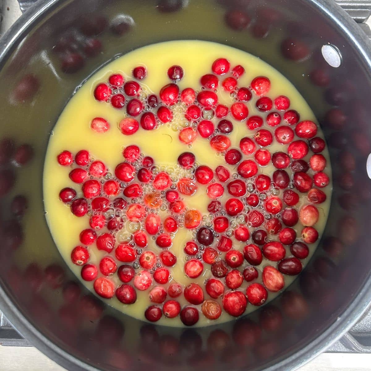 Pot with cranberries and orange juice. 