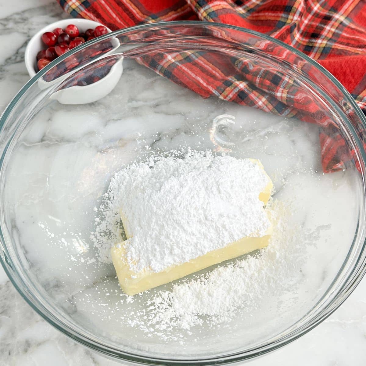 Bowl with butter, powdered sugar, and salt. 