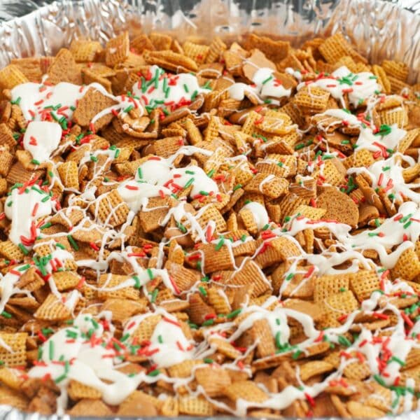 Pan with Chex Mix topped with white chocolate.