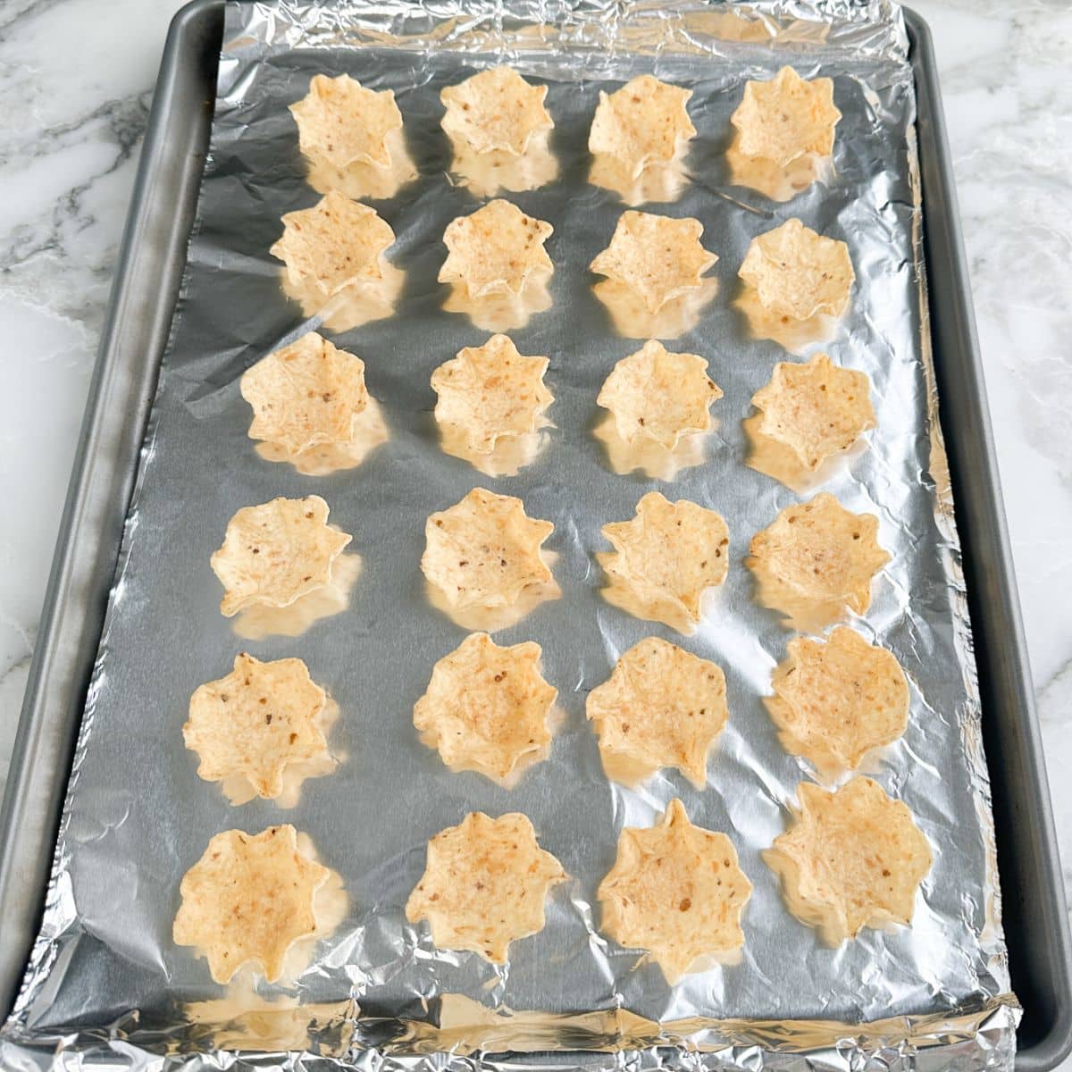 Cookie sheet with foil and Scoops chips.